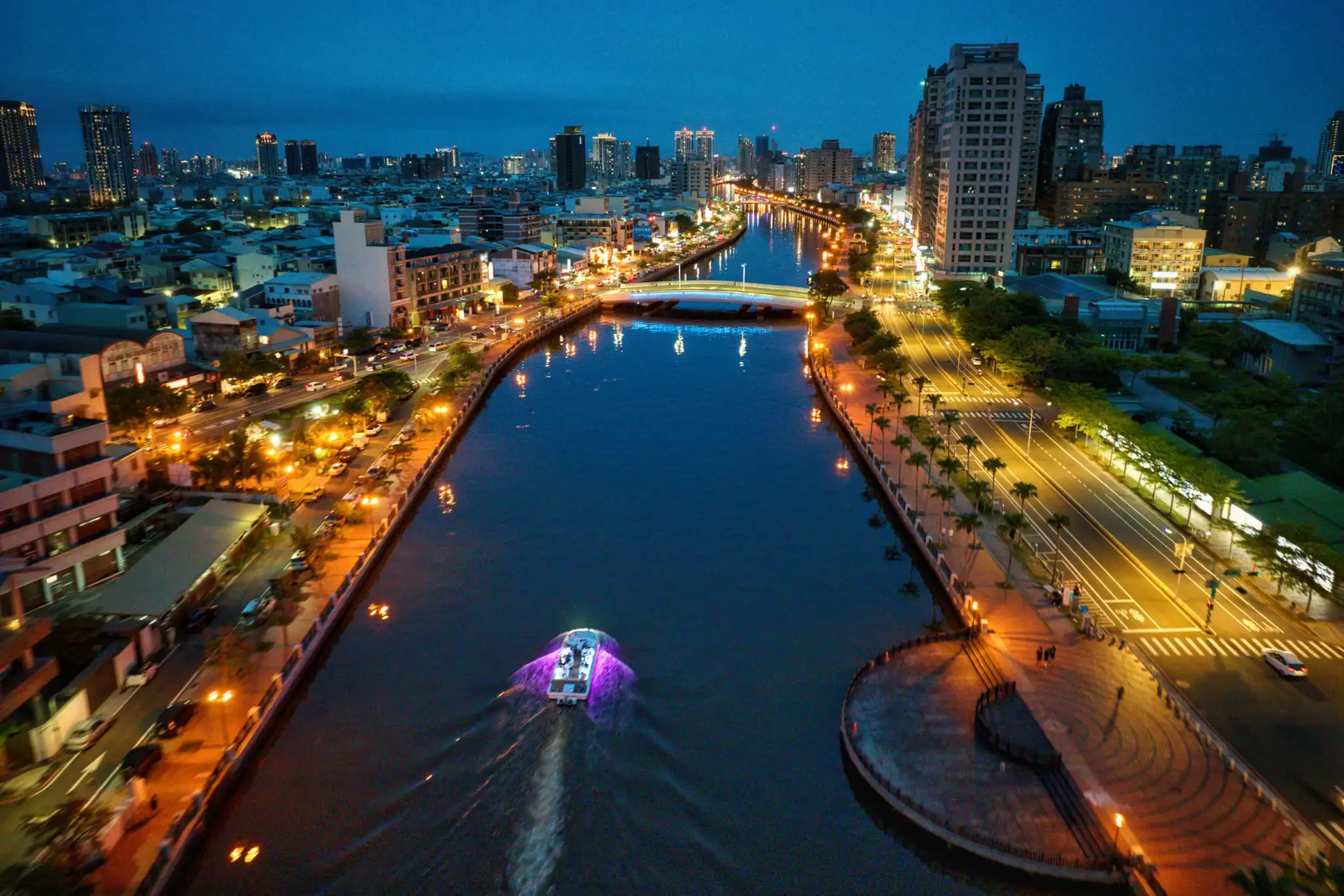 台南運河夜景燈火璀璨，遊船緩行水面，串聯兩岸城市風貌，展現百年運河融合歷史文化與現代都市發展的迷人景致。(圖/台南市政府提供)