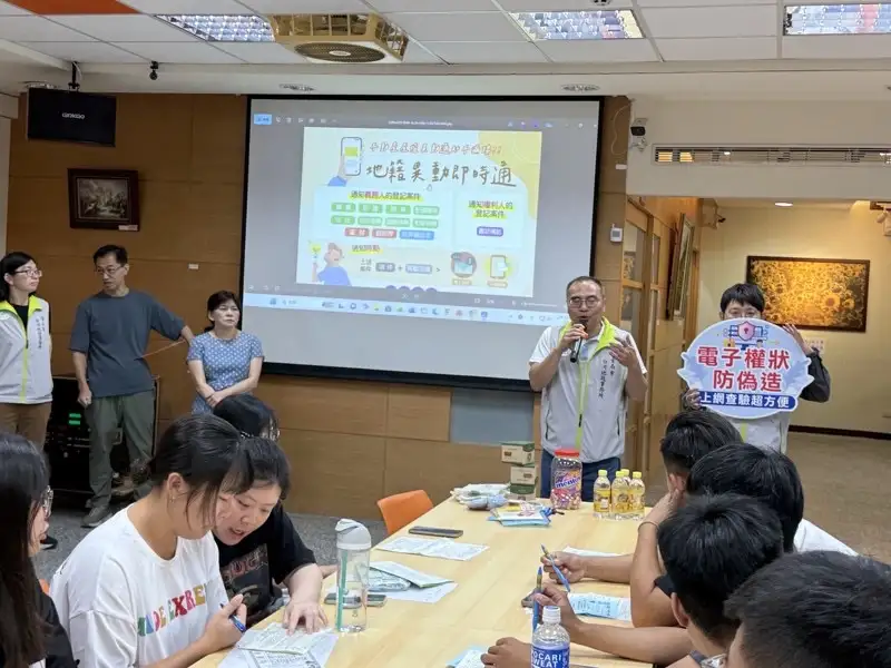 台南市地政團隊走入校園舉辦宣導活動，透過簡報與互動說明，向學生介紹「地籍異動即時通」及電子權狀防偽等不動產安全觀念，提升青年學子對個資保護與財產防詐騙的認識。(圖/臺南市政府地政局提供)