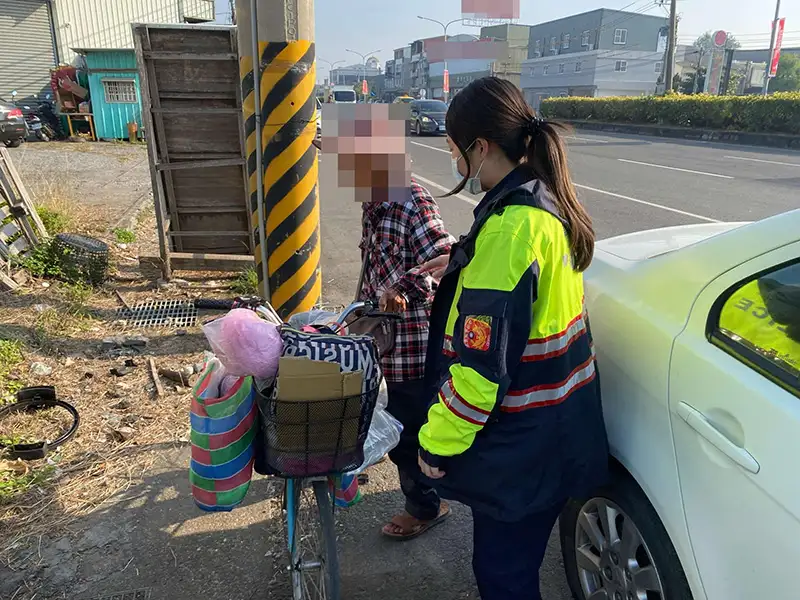 老婦牽著腳踏車在台1線快車道行走，員警立即上前指揮交通，將老婦攙扶至路旁。(圖/水上分局提供)