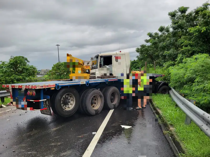 聯結車行經國道1號北向永康交流道匝道時疑因路滑自撞護欄，所幸駕駛僅輕傷無大礙。(圖/國道警察大隊提供)