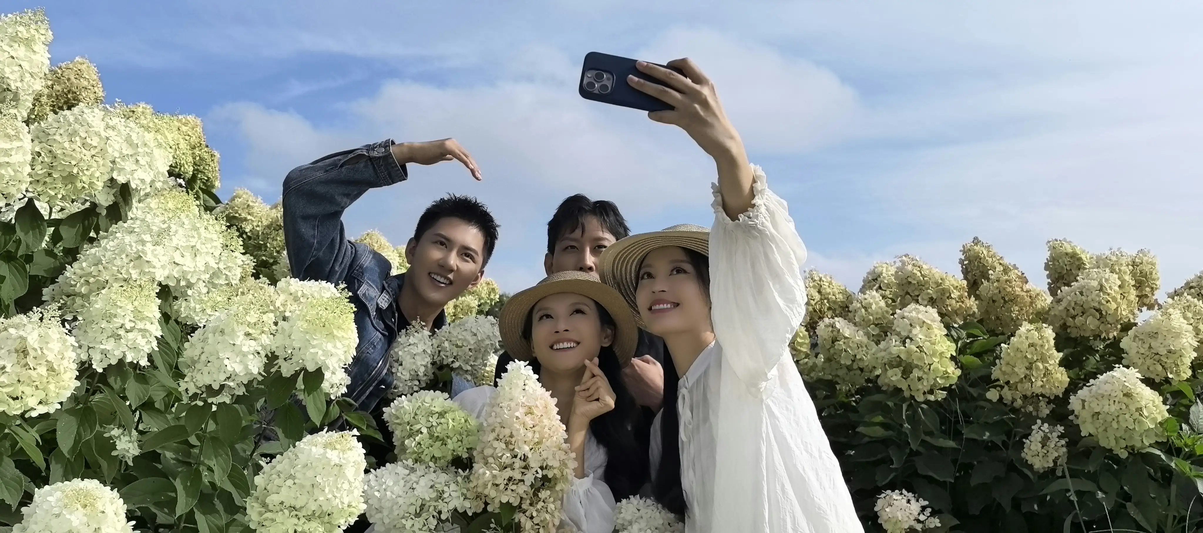 劇組演員在昆明南國山花園藝公司花海取景時合影留念，笑容與繁花同樣燦爛。(記者劉美祺翻攝)